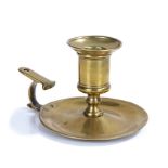 A George III brass chamberstick, circa 1770, having a large socket with reeded flared rim and short