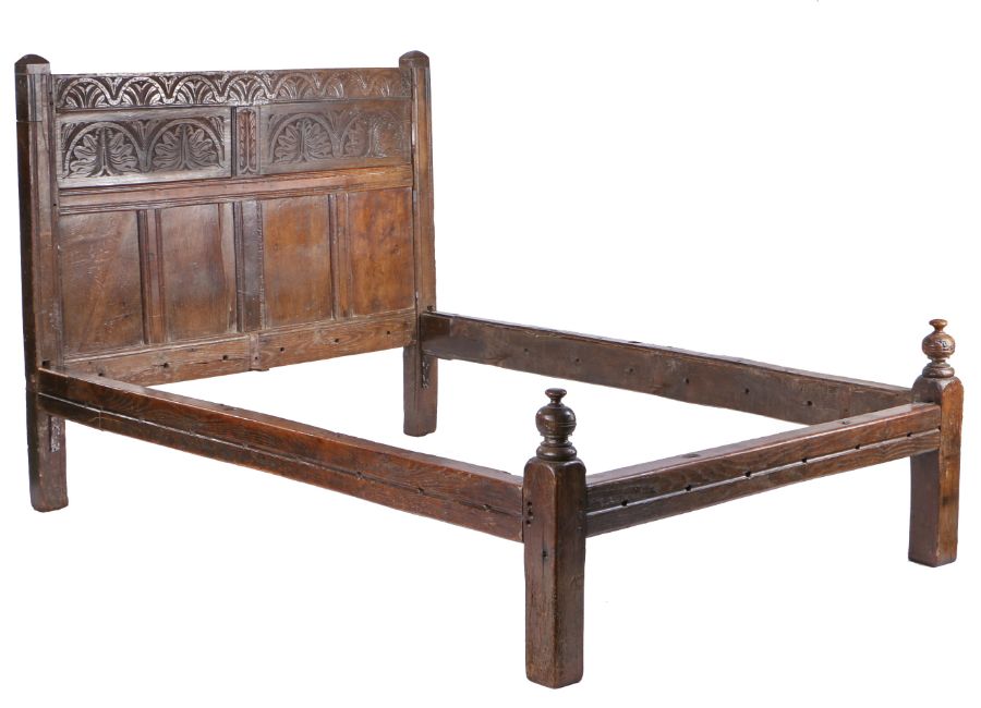Charles II and later oak bed, the lunette carved top rail atop two lunette and foliate carved
