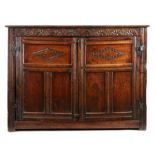 A Charles I oak livery cupboard, the rectangular top above a flower -filled lunette-carved  top
