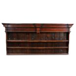 An 18th century oak dresser rack, having a bold breakfront cornice and frieze with end-pendants,