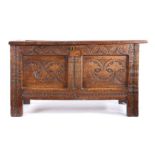 A Charles I oak coffer, Devon, the twin panel top  above a lunette-carved top rail and two panels