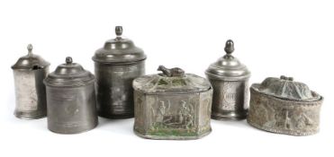 Six 19th century pewter/lead tobacco box and covers Four of circular form, three with an acorn knop,