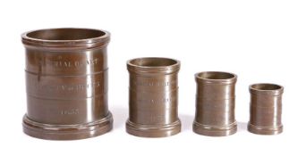 A Victorian set of four bronze-alloy Imperial Standard measures, each rim marked with Exchequer