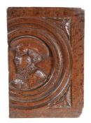 A small oak Romayne-type panel, circa 1540, designed with a male bust, wearing a bejwelled cap,