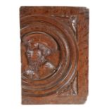 A small oak Romayne-type panel, circa 1540, designed with a male bust, wearing a bejwelled cap,