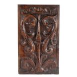 A 16th century deeply carved walnut panel, French, circa 1530, designed with with a central stem