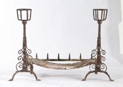 A pair of 18th/19th century cresset andirons, each with spit hooks and scroll decorated arched