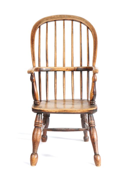 A mid-19th century ash and elm child's Windsor armchair, with hooped spindle -filled back, saddle