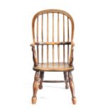 A mid-19th century ash and elm child's Windsor armchair, with hooped spindle -filled back, saddle