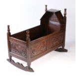 A Charles II joined oak canopied cradle, South-West Yorkshire, circa 1670 The triangular-shaped