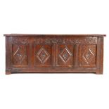 A Charles II oak coffer, West Country, circa 1660, the rectangular top above a leafy S-scroll