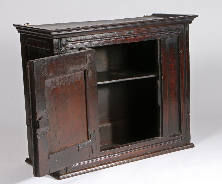 Charles II oak hanging cupboard, circa 1660, the concave cornice above a central panel door - Image 3 of 3