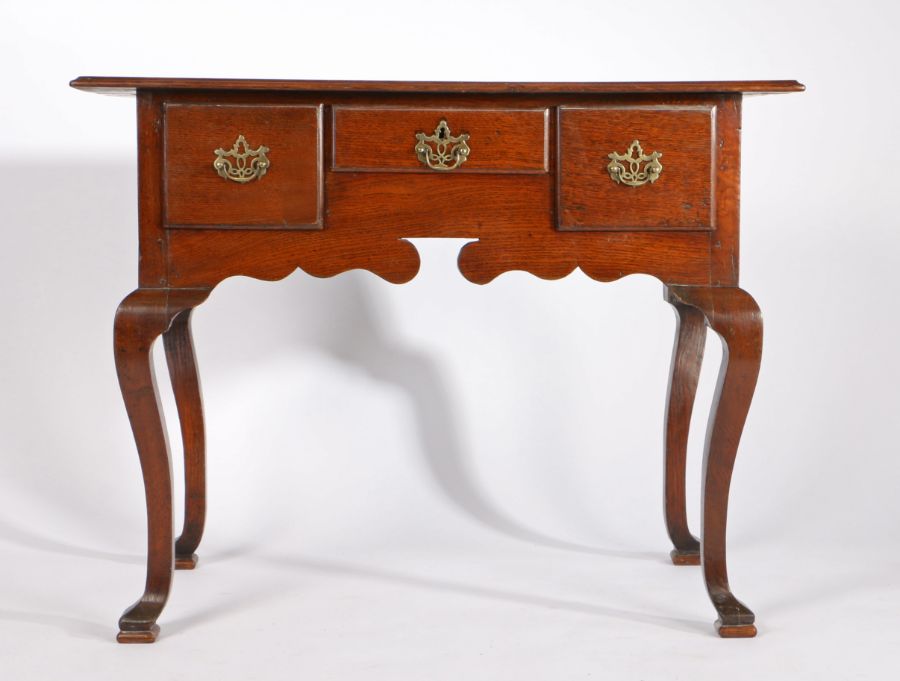 A George III oak lowboy, the rectangular top above three drawers and shaped apron, on cabriole - Image 2 of 3