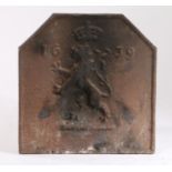 A cast iron fire back, of rectangular form with canted corners, designed with a crowned  lion