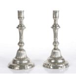 A pair of 18th century pewter candlesticks, circa 1760, French, each in the Rococo manner, the
