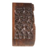 A 15th century walnut carved panel, French, deeply tracery carved with quatrefoils and leaves,