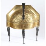 A late 18th century repouseé brass and iron curfew, Dutch, of semi-circular domed form, with loop