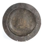 A pewter dish, probably 17th century, excavated, English Having a plain rim and flat well, the