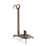 An 18th century iron cellar candle holder Designed to be hung over the edge of a barrel, having a