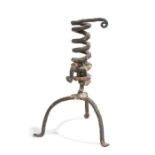 A 19th century wrought iron candlestick, French, with coiled stem and tripod base, 24cm high