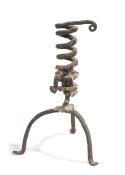 A 19th century wrought iron candlestick, French, with coiled stem and tripod base, 24cm high