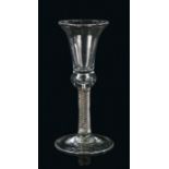 An 18th Century wine glass, the trumpet bowl above the exterior twist and conical foot, 17cm high