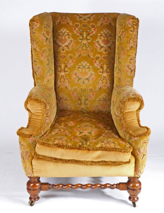 A Victorian walnut and upholstered wing armchair, the high padded back above a squab-cushion and - Image 2 of 2