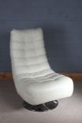 Cream leatherette upholstered swivel chair, raised on a flared chrome foot