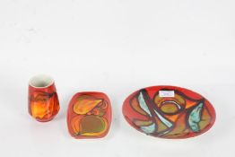 Three pieces of Poole pottery Delphis, comprising a vase 9cm, rectangular dish (18cm) and shallow