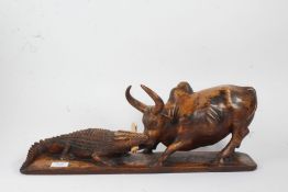 Indian carved wooden figure group, in the form of a crocodile and buffalo, 50cm long