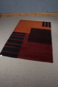 Mid 20th Century carpet, the red and orange ground with black baton decoration, 182cm x 122cm