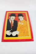 Laurel and Hardy tin sign, decorated in bright colours, 56cm high, 40.5cm wide