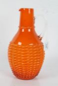 Bright orange glass jug, with weaved basket effect body, 30cm tall