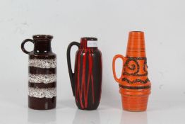 Three West German pottery vases, one with white lava effect on brown ground, 20.5cm tall, the second