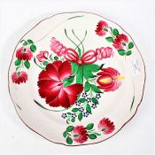 Enamel decorated porcelain plate depicting red flowers top the center and border, 30.5cm diameter