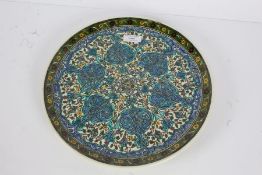 Turkish pottery plate, brightly glazed with floral motifs, marked 'Kutahya' to back, 31cm diameter