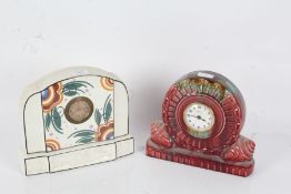 Two pottery mantle clocks, the first of circular form with green, brown and maroon running glaze,