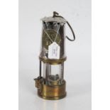 Miners lamp made by Eccles with a brass reservoir to the base, 25cm high