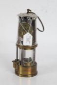 Miners lamp made by Eccles with a brass reservoir to the base, 25cm high