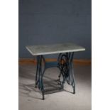 Cast iron treadle sewing machine table, having white marble top raised on a later painted base in