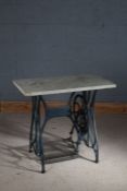 Cast iron treadle sewing machine table, having white marble top raised on a later painted base in