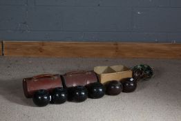 Two pairs of ebony bowling woods, each housed in leather carrying cases, and two pairs of lignum