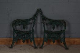 Pair of cast iron bench ends, painted in green, 83cm high