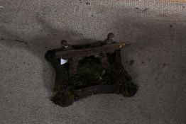 Cast iron boot scraper, with shaped scrolling feet, indistinct marks to base, 30cm square