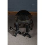 Cast iron fire basket, the back plate with ribbon tied decoration, 55cm wide, together with a pair