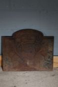 Cast iron fire back, depicting a coat of arms, 58cm wide, 50cm high