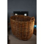 Very large Norfolk made wicker log basket, with carrying handles, 105cm wide, 87cm high