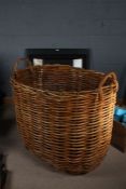 Very large Norfolk made wicker log basket, with carrying handles, 105cm wide, 87cm high