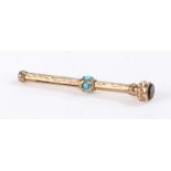 Unmarked Gold coloured metal extending pencil, set with turquoise stones to the side and garnet to