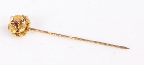 15 carat gold stick pin set with a central ruby to the head in the form of a flower, weight 1.6
